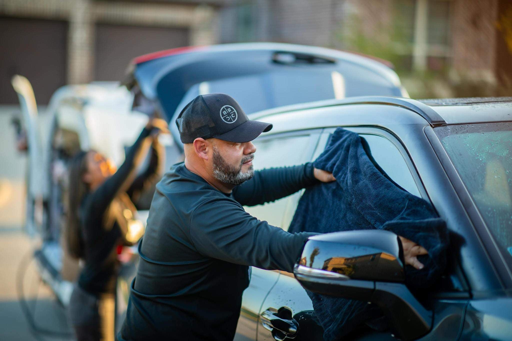 Revive detailer cleaning a vehicle mirror